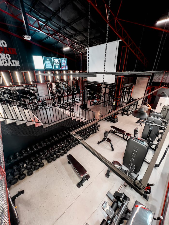 Spacious gym interior featuring a variety of fitness equipment and weights, perfect for workouts.